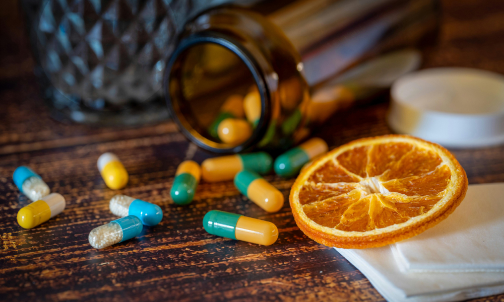 kapsułki NAC wysypujące się z pojemnika na stół